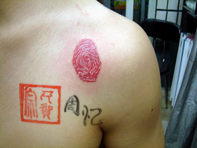 Fingerprint tattoo below the shoulder