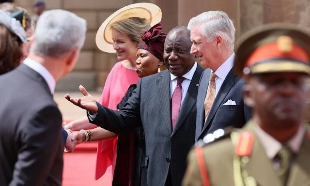 Queen Mathilde wore a fuchsia pink cape silk dress by Natan. President Cyril Ramaphosa and Minister Lindiwe Zulu