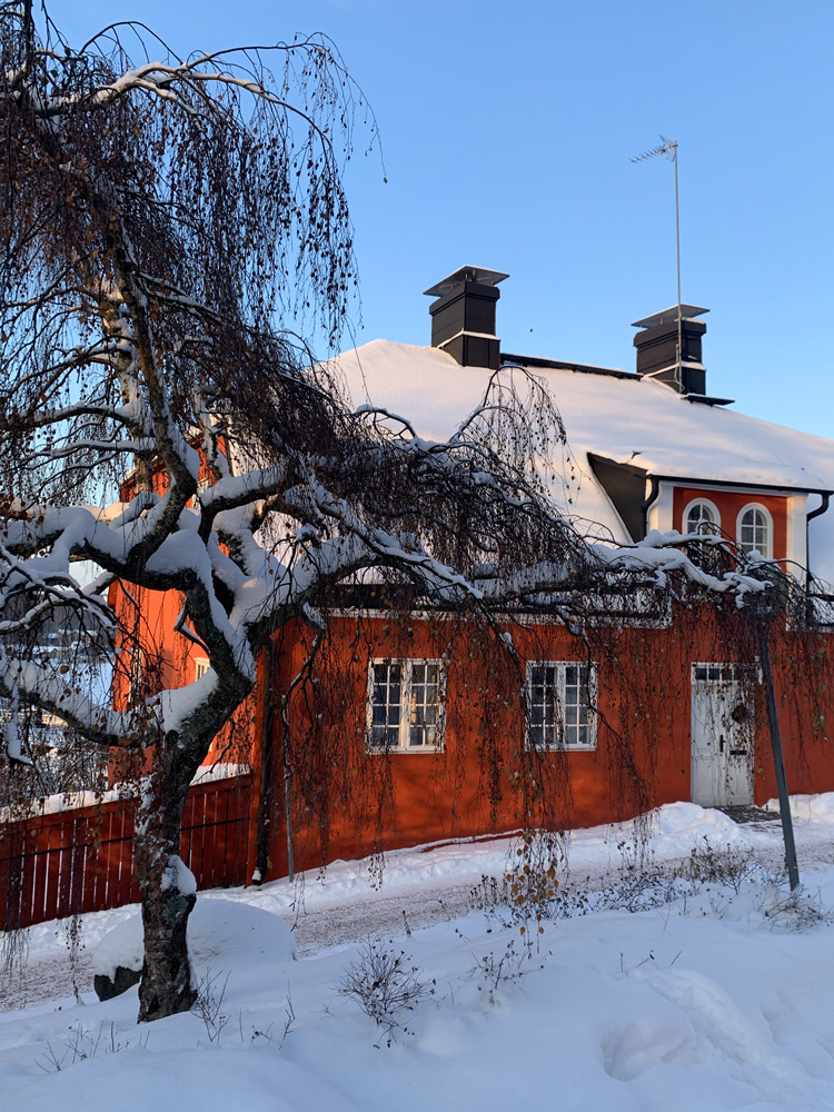 A beautiful coral colored house with a mansard roof