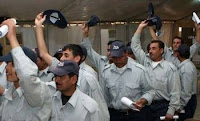 Iraqi policemen celebrate their graduation at al Anbar Ramadi District Training Headquarters in May. (Marine Corps photo by Lance Cpl. Casey Jones)