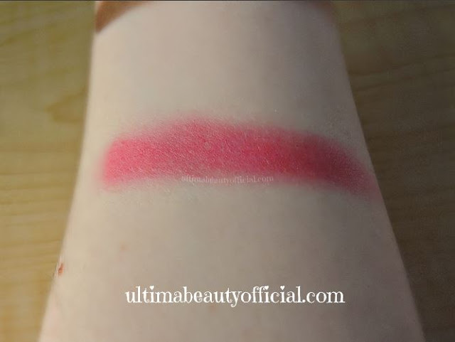 Swatch of Cailyn tinted lip balm in the shade 13 Coral on Ultima Beauty's arm