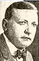 Headshot from a news clipping showing a white man with short dark hair and fine features, weaing a bow tie