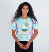 Woman with long hair wearing tie dye t-shirt with logo