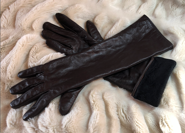 Pair of long brown leather winter gloves with one cuff turned back to show plush fleece lining