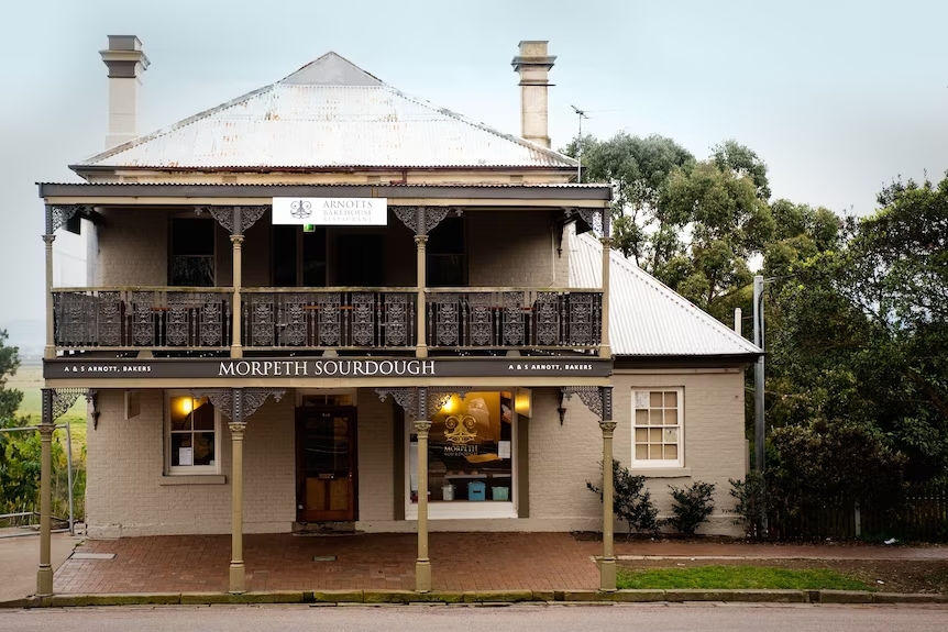 From Biscuit Beginnings to Modern Marvel: The Arnott Family's Historic Morpeth Bakehouse Arnott's biscuits, an Australian household name for 160 years, have a fascinating origin story.  The historic Arnott's bakehouse in Morpeth, where it all began, still operates under the family's ownership.    A Family Legacy    - Steve Arnott, inspired by his family's legacy, purchased the bakehouse in Morpeth in 2001.     - Formerly an antique store, Steve and his wife Allison transformed it into a bakery, keeping the tradition alive.     - Steve, a sixth-generation baker, felt compelled to continue the family's baking heritage.    Restoring the Past    - Steve and Allison undertook the restoration of Australia's oldest scotch oven, located in the Morpeth bakery.     - Scotch ovens are wood-fired commercial ovens with a distinctive arched ceiling, made of bricks.     - The oven in the Morpeth bakery was used to bake the first Arnott's biscuits in 1847, albeit different from the current offerings.    From Humble Beginnings    - William Arnott, the founder, emigrated from Scotland and established his first bakery on the Hunter River in Morpeth in 1847.     - Morpeth, a bustling river port, served as a destination for ships from the UK and the Americas, creating high demand for Arnott's ships biscuits.     - Despite floods, William relocated to Newcastle in 1865 and expanded his business, ultimately founding the famous Arnott's Steam Biscuit Factory in 1875.    Building an Empire    - By the late 1880s, Arnott's had become one of Newcastle's largest employers, with over 300 staff producing a range of biscuits, including the iconic Milk Arrowroot.     - In 1894, the first Sydney factory was established, solidifying Arnott's position as a biscuit empire.     - Arnott's continued to grow and diversify its product range, captivating consumers worldwide.    The Present and Beyond    - Steve and Allison have transitioned from full-time baking to teaching others the art of making sourdough.     - The bakehouse now operates as a guesthouse, showcasing the Arnott's memorabilia collected over the years.     - The future of the Arnott family's involvement in Morpeth remains uncertain, as Steve's son pursues a different career path.     - However, Steve remains optimistic, acknowledging that his own baking journey began later in life, leaving room for future generations.    Legacy and Change    - While the Arnott's family tradition in Morpeth may evolve, the Arnott's Biscuit company itself was acquired by the Campbell Soup Company in 1997.     - The legacy of Arnott's biscuits lives on, with the Morpeth bakehouse serving as a testament to their rich history.