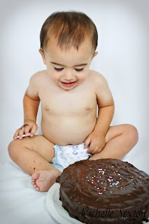 baby looking at chocolate cake