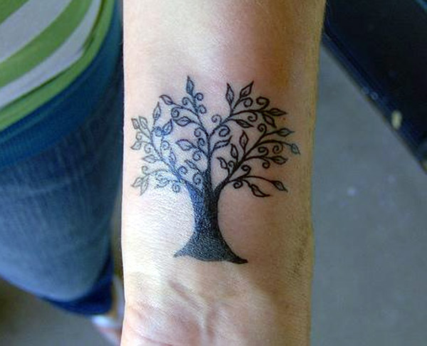 This is an awesome and beautiful wrist tattoo it's so amazing tree blackwork tattoo designs on the wrist for female