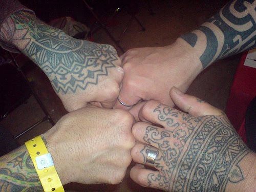 Tribal hand tattoos.