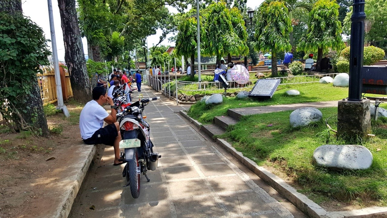 residents watch a giant TV inside Victorias City Public Park