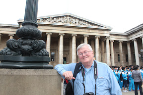 Dad holding up a lamppost outside the British Museum