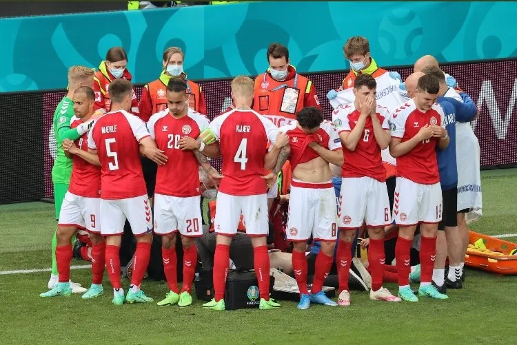 Denmark players form a ring around Christian Eriksen to shield the distressing scenes from the rest of the world