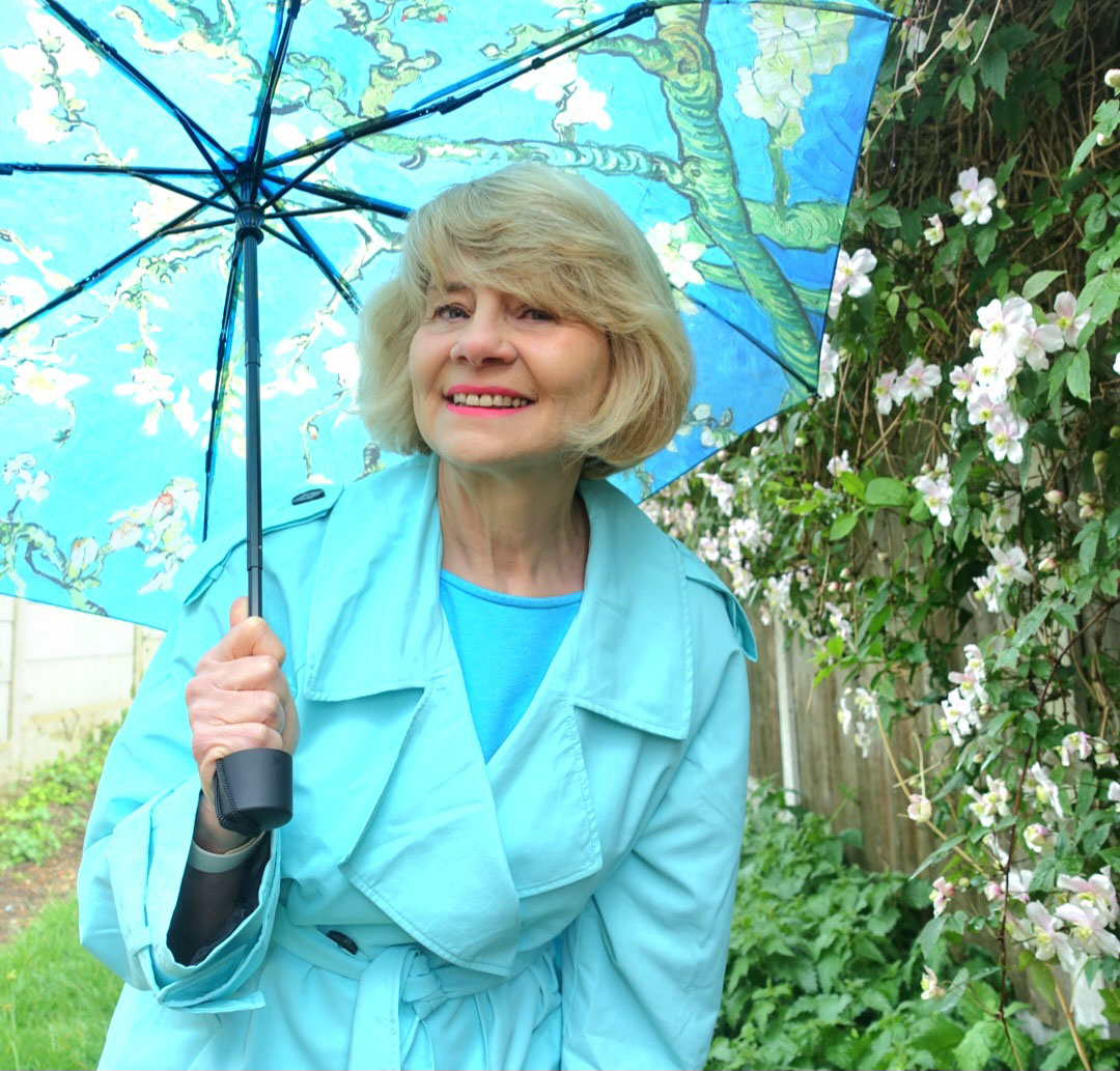 A turquoise trench and Monet umbrella keeps Is This Mutton's Gail Hanlon smiling through the rain