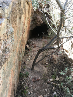 A narrow cut leads up to the main entrance of the Betty Lee Mine