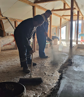 Adding cement dust and scrubbing it in with a broom