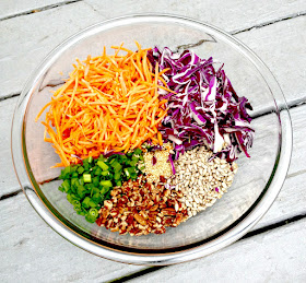 Bowl of shredded carrots, red cabbage and pecans and sesame seeds