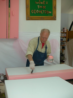 Artist Jay Rolfe is shown here yesterday painting one of his new 3-D shaped stretched canvas paintings of "Princess Pocahontas and John