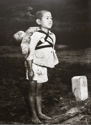 The picture of a boy who brought his dead brother for cremation worth a thousand words