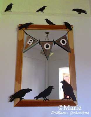 A small handmade banner or garland decorates a mirror for Halloween