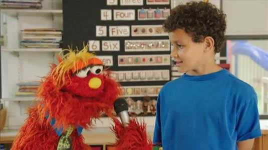 Sesame Street Episode 4521. Murray interviews a boy about school rules. Ovejita explains the Spanish equivalent of the word school, escuela.
