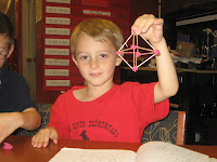 Student holding up an octahedron he made from toothpicks and clay