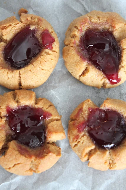 Close-up of peanut butter and jelly thumbprint cookies.