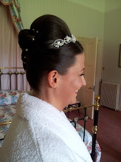 Bride with sleek french roll, detailed with diamante hair pins