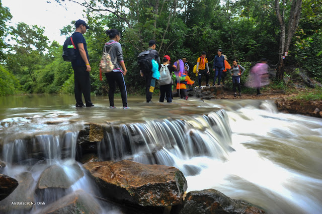 Crossing stream in the trekking route of Dinh Hills