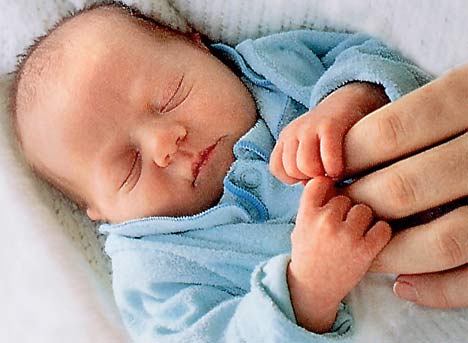 Cute Baby Boy Sleeping by holding mothers Hand
