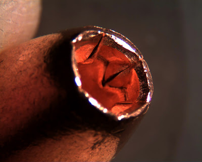 side view of all copper bullet showing internal expansion cuts