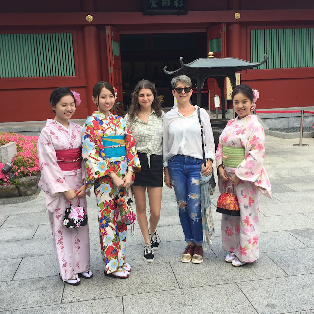 Taking photo with traditionally dresses young women 