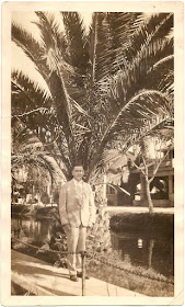 Leo Harrington standing in front of palm tree near canal or waterway