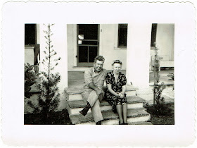 Reubin Childers and Aina T Persson Childers sitting in front of their home in Fort Meade Florida