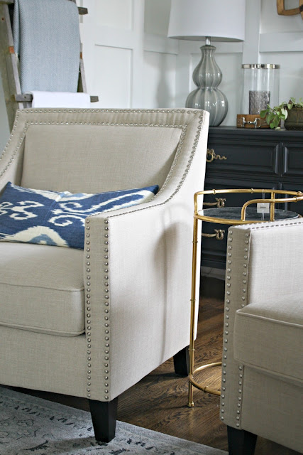 Neutral arm chair with nailhead trim