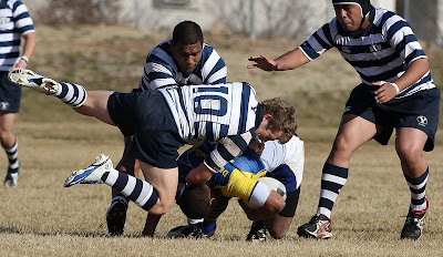 BYU Rugby Flyhalf Dylan Lubbe pounces on a Delaware player to contain the opposition's momentum