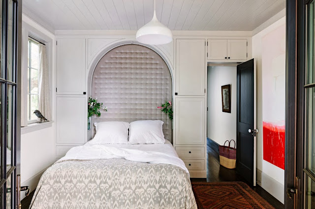 Bedroom with built in tufted arch headboard
