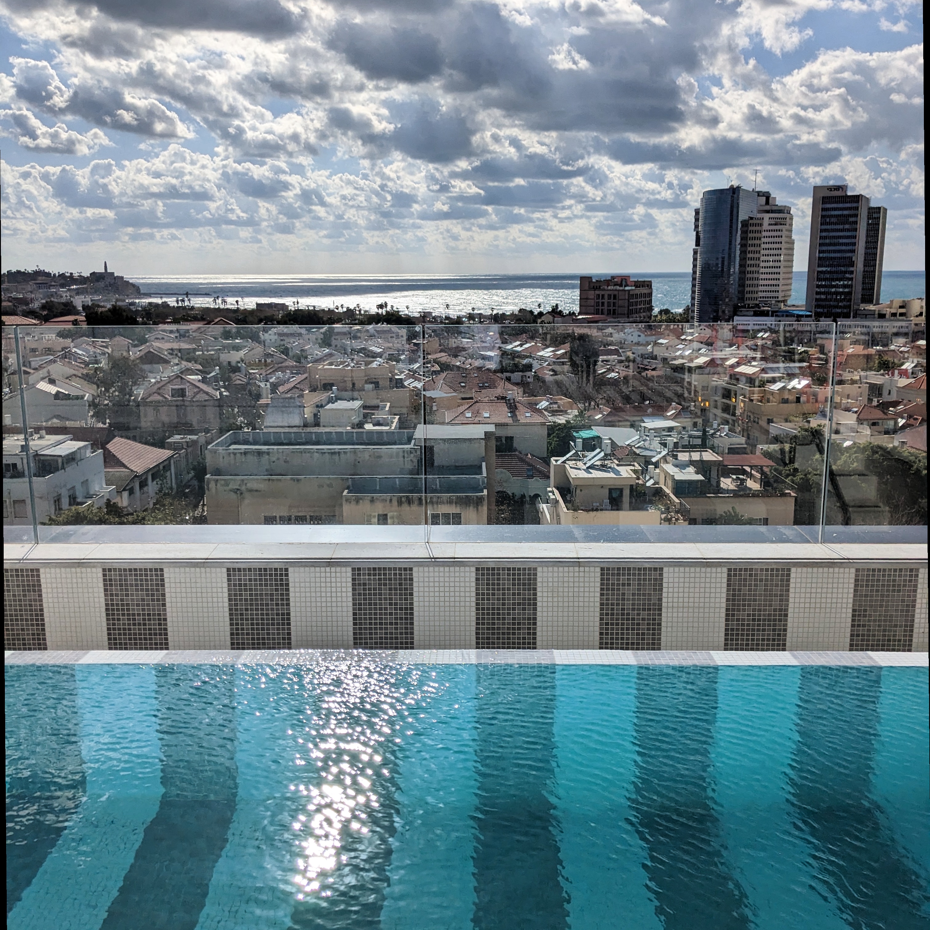 rooftop pool with views looking out over Tel Aviv at the Elkonin hotel