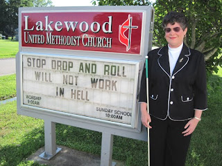 Laurel standing by Lakewood UMC sign