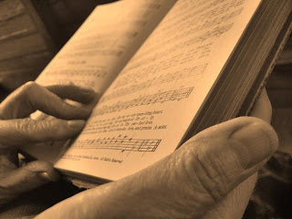 Hands holding hymnal