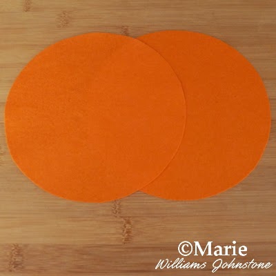 2 overlapped circles of orange color felt fabric