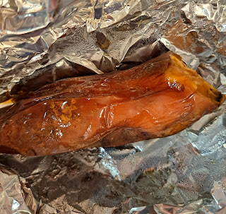 Baked sweet potatoi lying in foil.