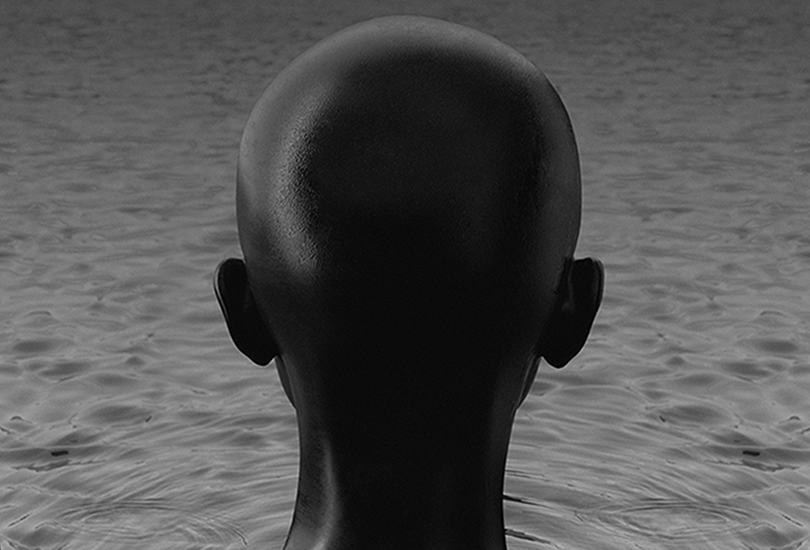 A 3D render of Kelela, facing away from the camera, up to her neck in water.