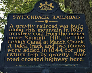 A gravity railroad was built along this mountain in 1827 to carry coal from the mines near Summit Hill to the Lehigh Canal at Mauch Chunk. A back-track and two planes were added in 1844 for the return trip by gravity. Railroad crossed the highway here.