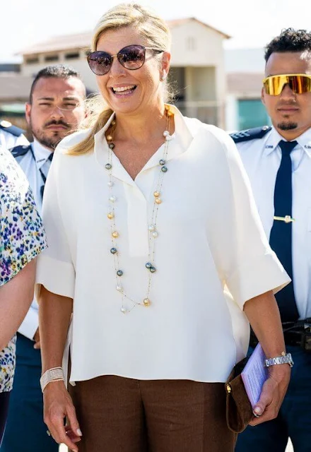 Princess Amalia wore a Vaige top by Munthe, and dancing yellyfish earrings by Barong Barong. Maxima wore a silk blouse by Natan