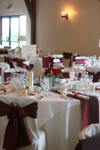  with a hand tie of Delphiniums Burgundy Roses and Burgundy Gerbera