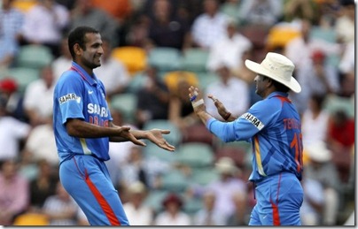 India's Irfan Pathan (L) celebrates with teammate Sachin Tendulkar after he took the wicket of Australia's David Warner during their one-day international cricket match in Brisbane Febru