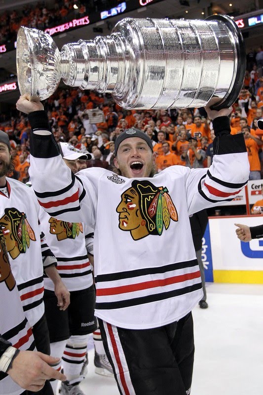  Patrick Kane #88 of the Chicago Blackhawks hoists the Stanley Cup after 