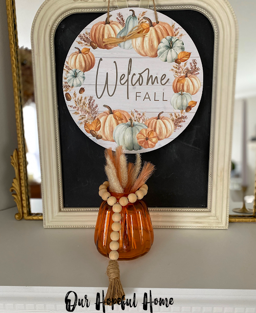 Welcome Fall sign amber jar filled with fall floral picks