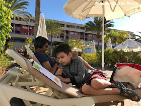 Family relaxing on sunloungers