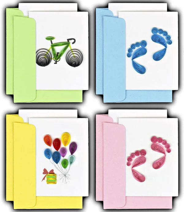 four quilled cards with envelopes featuring a bicycle, balloons, and pink and blue baby footprints