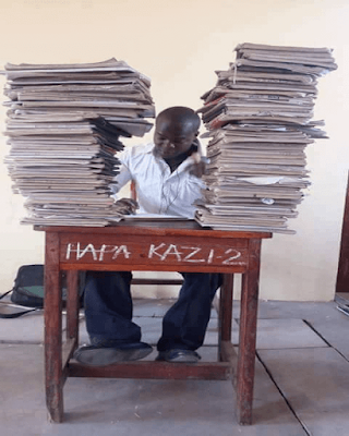 A teacher in staffroom marking. PHOTO | Courtesy